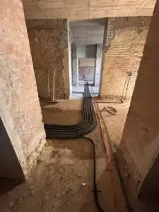 Electrical rewiring in progress during apartment renovation with wall chasing.