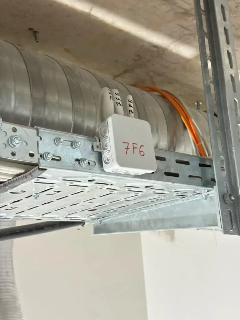 Wurth installation box mounted on a cable tray next to an HVAC duct, labeled for circuit 7F6.