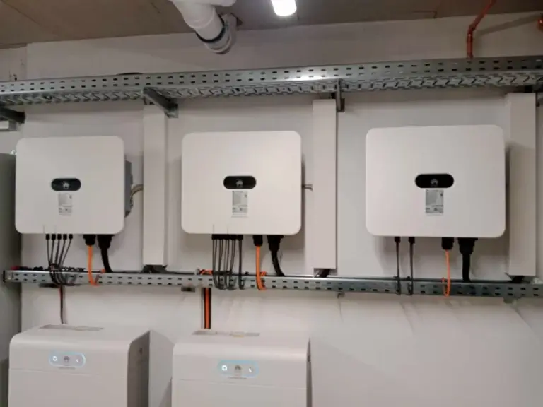 Three Huawei inverters installed in line as part of a solar energy setup.